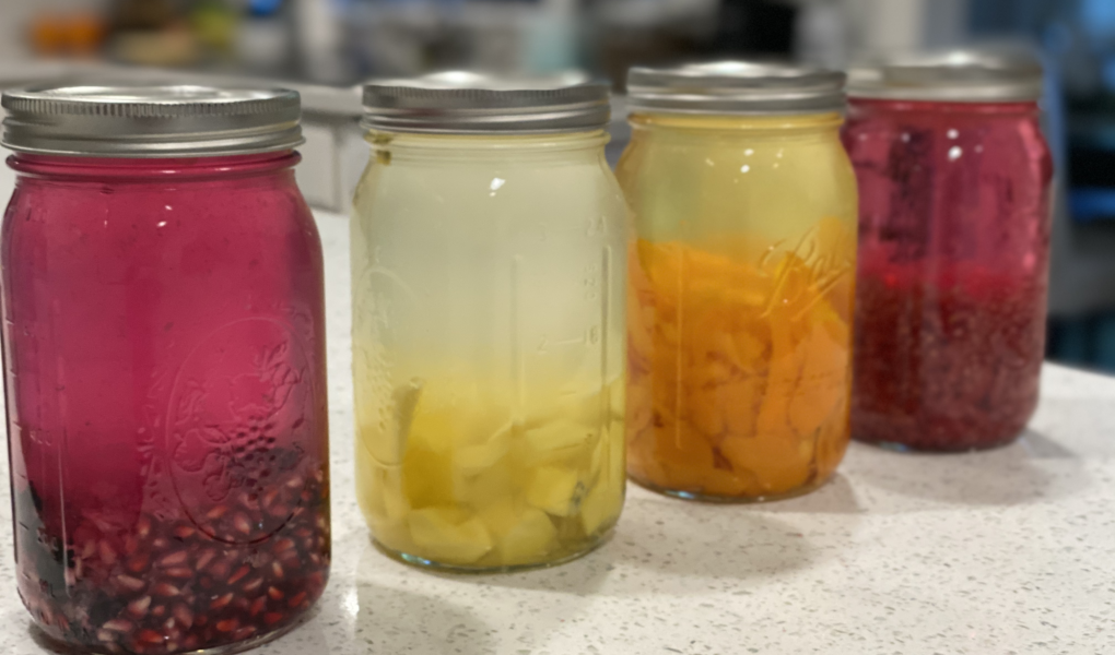 4 Jars showcasing infusing vodka with different fruits