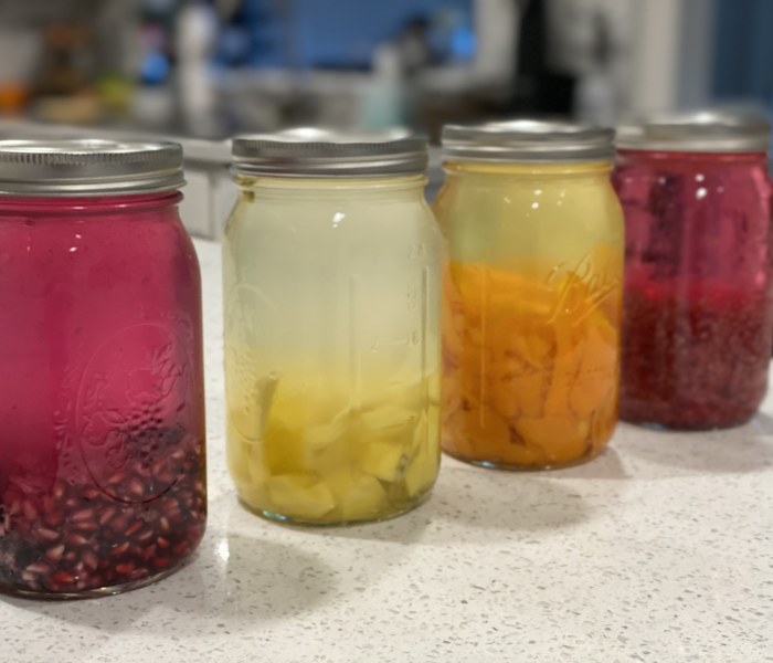 4 Jars showcasing infusing vodka with different fruits