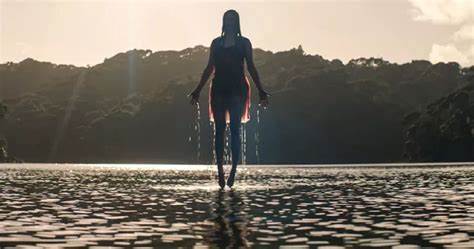 woman floating over lake in blood stained gown