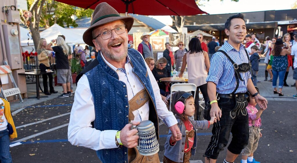 spirited community in traditional clothing at downtown oktoberfest